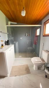 a bathroom with a toilet and a sink at Casa de campo Cantinho dos Serranos in São Joaquim +17 photos