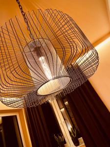 a large metal fan hanging from a ceiling at Uniejów Apartments in Uniejow