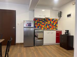 a kitchen with a stainless steel refrigerator and a stove at 14 Departamento acogedor y nuevo en Miraflores in Lima