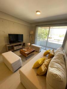 a living room with a large couch and a television at Amplio y lujoso departamento in Mendoza