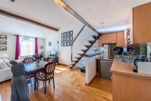 a kitchen and living room with a dining table and a staircase at Samourai Massena Lodge -1 min from the sea in Nice