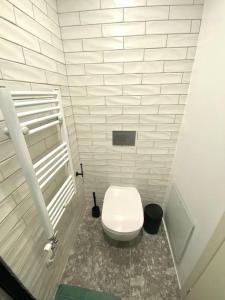 a bathroom with a white toilet in a stall at Piraeus Apartment for rent in Piraeus