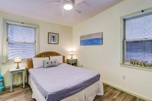 a bedroom with a bed and two windows at Moonshell 3 in Hilton Head Island