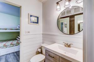 a bathroom with a sink and a mirror at Moonshell 3 in Hilton Head Island +33 photos