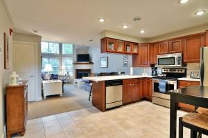 a large kitchen with wooden cabinets and a kitchen island at Unit 207 2 BDRM 2 BA condo in Birchwood
