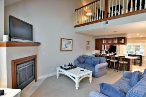 a living room with a fireplace and a tv at Unit 207 2 BDRM 2 BA condo in Birchwood