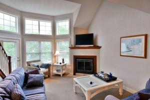 a living room with a couch and a fireplace at Unit 207 2 BDRM 2 BA condo in Birchwood