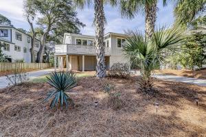 a house with palm trees in front of a driveway at Moonshell 3 in Hilton Head Island