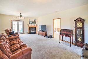 a living room with a couch and a grandfather clock at Waterfront Montross Home with Private Boat Slip! in Montross