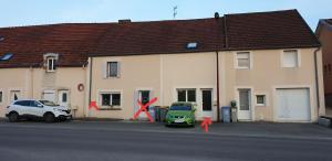 a green car parked in front of a building at Maison duplex de ville avec terrasse et clim in Foucherans