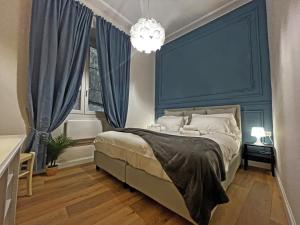 una camera da letto con un letto grande con testiera blu di Happy Family Apartments Rovere a Genova