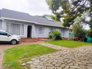 a white car parked in front of a house at Sabie House -3 bedroom house in Kempton Park