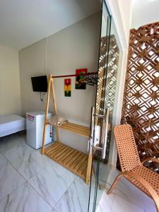 a room with a bed and a glass door at Pousada Caminho de Moises in Maragogi