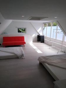 a room with two beds and a red bench at Barn in beautiful Countyside in Watford