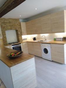 a kitchen with a bowl of fruit on a counter at Barn in beautiful Countyside in Watford