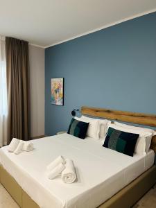 a bedroom with a large bed with towels on it at Avio Suite in Naples