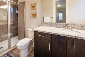 a bathroom with a toilet and a sink and a shower at Paradise Village 107 Private Pool, Hot Tub, Pickle-ball, Basketball, Futsal Court, and Game Room in Santa Clara