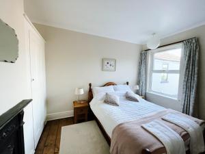 a bedroom with a bed and a window at The Anchorage , Gorleston on Sea in Gorleston-on-Sea