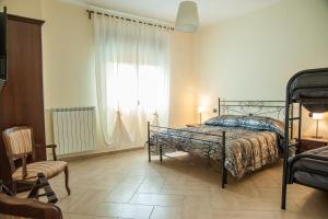 a bedroom with a bed and a large window at B&B La Cannalia in Teana +33 photos