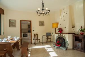 a living room with a table and a fireplace at B&B La Cannalia in Teana