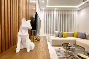 a living room with a white dog statue in a room at The Suite of Artists - Central - By AppartAli in Casablanca