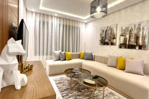a living room with a couch and a glass table at The Suite of Artists - Central - By AppartAli in Casablanca +26 photos