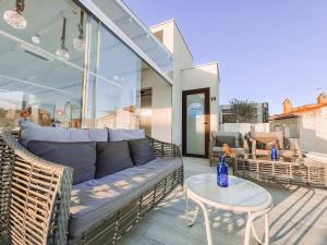 a couch and a table on a patio at Mamma Mia Hotel Boutique - Only Adults in Tossa de Mar