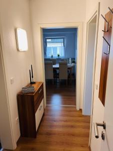 a hallway with a dining room and a dining table at Ferienwohnung Götel in Gladbeck