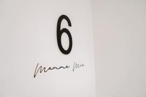 a number written in black on a white wall at Mamma Mia Hotel Boutique - Only Adults in Tossa de Mar