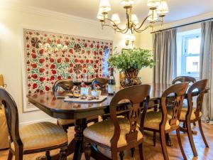 a dining room with a wooden table and chairs at Auchengool House in Kirkcudbright