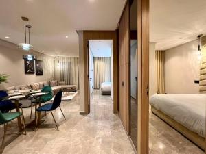 a hotel room with a bed and a table and chairs at Centro 2 Bedrooms- By AppartAli in Casablanca