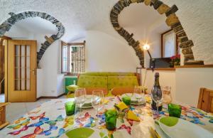 a dining room with a table with wine glasses at Casa Almut & More - Lake Como Center - Varenna in Perledo