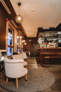 a restaurant with white chairs and a bar at Mamma Mia Hotel Boutique - Only Adults in Tossa de Mar