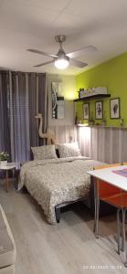 a bedroom with a bed and a ceiling fan at Apartamento Oliver in Calella