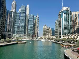 a river in a city with many tall buildings at Jewellery Homes in Continental tower Dubai Marina in Dubai