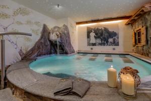 a large swimming pool in the middle of a room at Agritur Darial in Tesero
