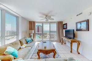 uma sala de estar com um sofá e uma televisão em Pelican Beach Resort 818 em Destin