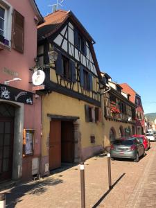 a building on a street with a car parked in front at Gite les Remparts de Turckheim in Turckheim