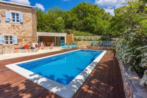 a swimming pool in the backyard of a house at Villa Bell Aria in Grižane