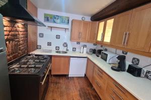 a kitchen with wooden cabinets and a stove top oven at Duplex de Prestige in Troyes +3 photos