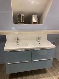 a bathroom with a sink and a mirror at Gite les Remparts de Turckheim in Turckheim +20 photos