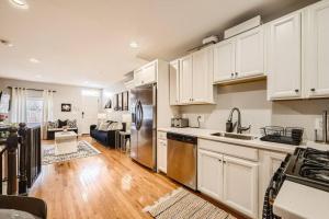 a kitchen with white cabinets and stainless steel appliances at Trendy Spot in Downtown Baltimore/Fellspoint in Baltimore