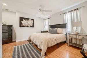 a bedroom with a bed and a dresser and a ceiling fan at Trendy Spot in Downtown Baltimore/Fellspoint in Baltimore
