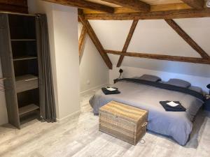 a bedroom with a bed in a room with wooden ceilings at Gite les Remparts de Turckheim in Turckheim
