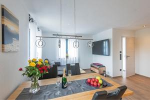 a kitchen and dining room with a table with fruit on it at Seelodge in Bad Bayersoien