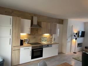 a kitchen with white cabinets and a stove top oven at Villa Lahr in Lahr