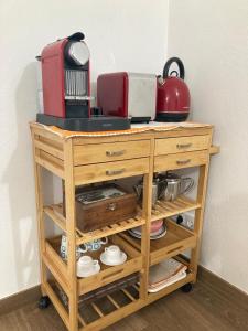 a wooden cabinet with a counter top with appliances on it at Casa da Nazaré in Portinho da Arrábida