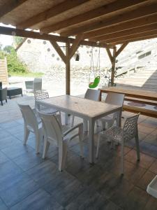 a white table and chairs on a patio at Peyo et Foodie in Escou