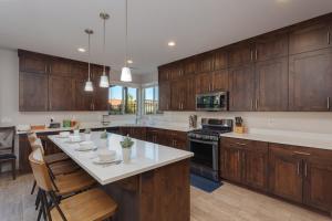 a kitchen with wooden cabinets and a white counter top at 96 PV Luxury Getaway with Private Hot Tub, Ping Pong, Community Pool, Water Park and Lazy River in Santa Clara