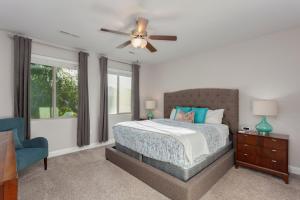 a bedroom with a bed and a ceiling fan at 96 PV Luxury Getaway with Private Hot Tub, Ping Pong, Community Pool, Water Park and Lazy River in Santa Clara